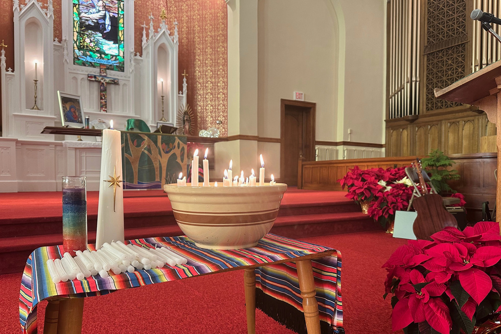 Candles burn inside St. Paul's-San Pablo Lutheran Church in Minneapolis, Sunday, Jan. 11, 2026. (AP Photo/Rebecca Santana)