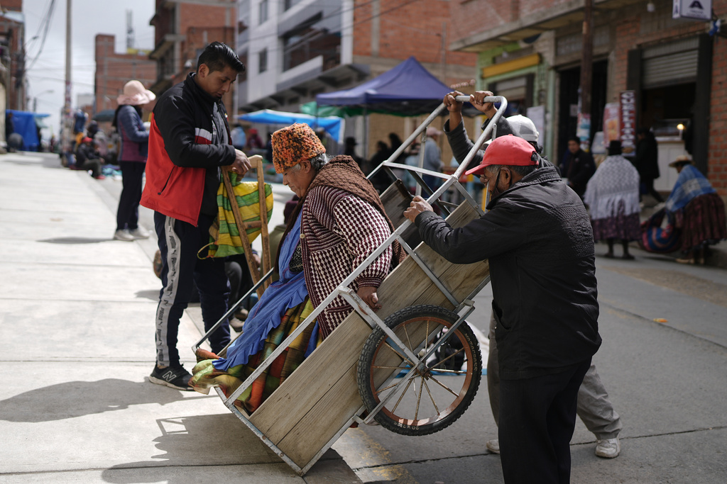 A woman arrives to a polling station to vote in a presidential runoff election in El Alto, Bolivia, Sunday, Oct. 19, 2025. (AP Photo/Ivan Valencia)