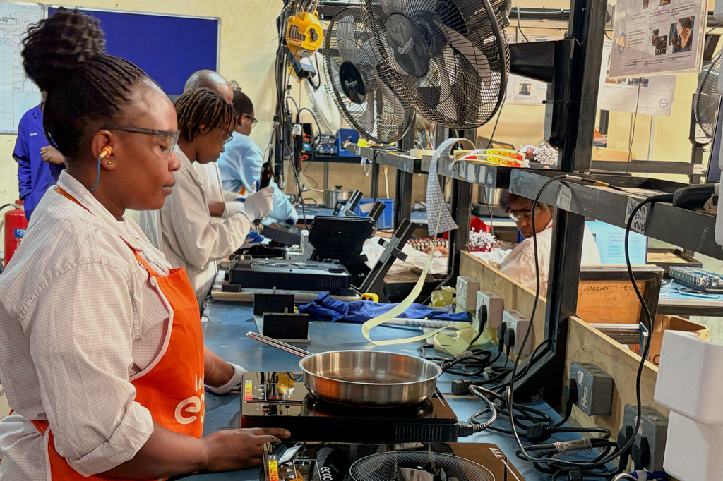 Workers assemble fuel-efficient cookstoves at BURN, a manufacturer of clean cooking appliances, in Kiambu, Kenya, on July 31, 2026. (AP Photo/Allan Olingo)