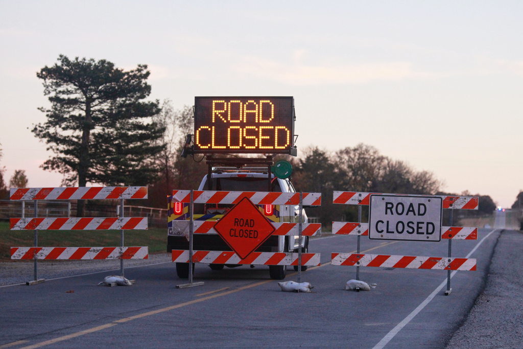 Law enforcement blocks a two-lane road into Carbondale, Kan., due to a shooting that resulted in multiple casualties, Saturday, Nov. 15, 2025. (AP Photo/John Hanna)