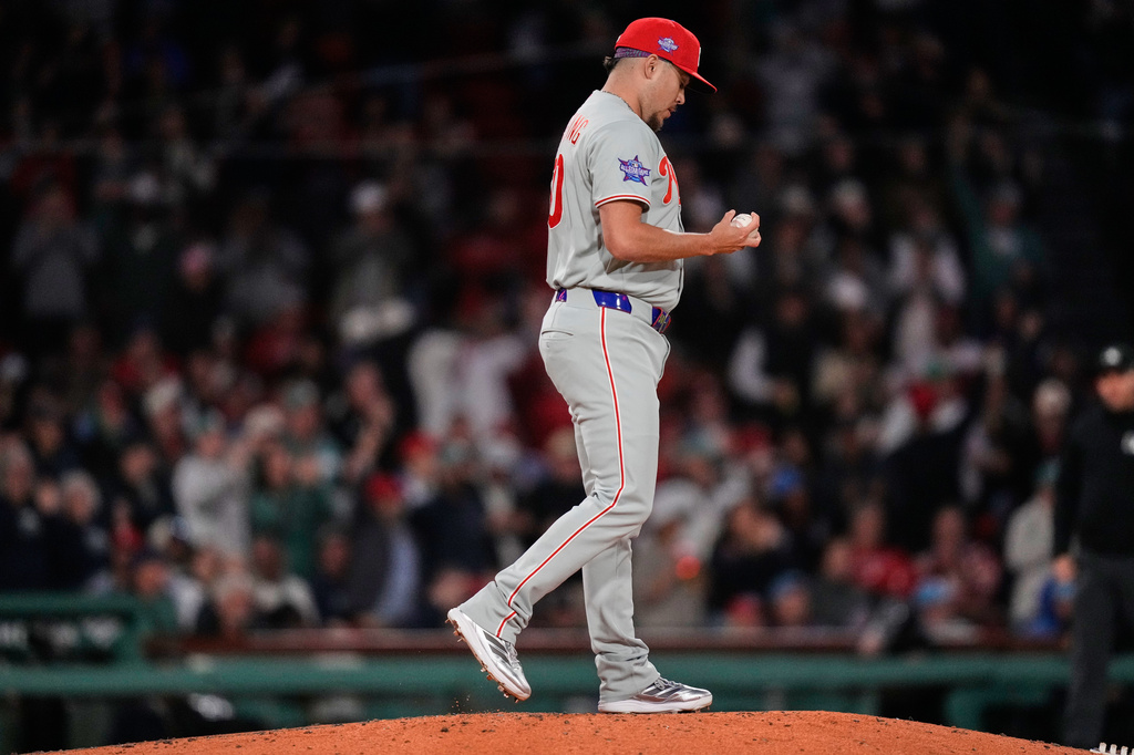 Philadelphia Phillies pitcher Orion Kerkering looks down at a fresh baseball after giving up a two-run home run to Boston Red Sox's Ceddanne Rafaela during the sixth inning of a baseball game, Wednesday, May 13, 2026, in Boston. (AP Photo/Charles Krupa)