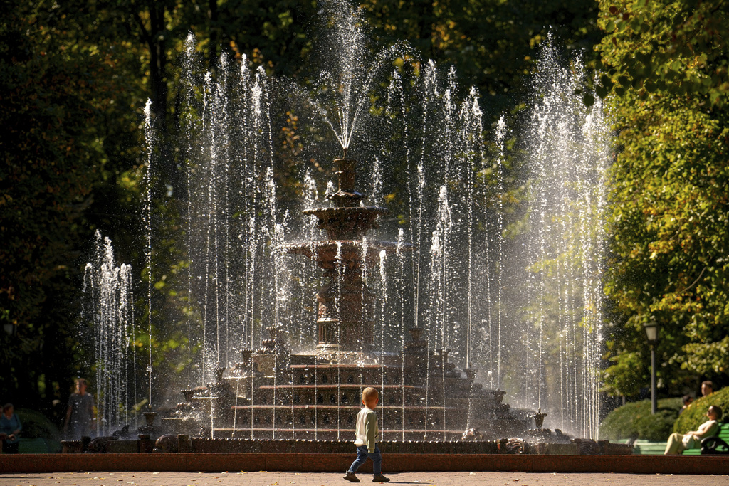 A child walks past a city fountain in a park in Chisinau, Moldova, Tuesday, Sept. 23, 2025. (AP Photo/Vadim Ghirda)