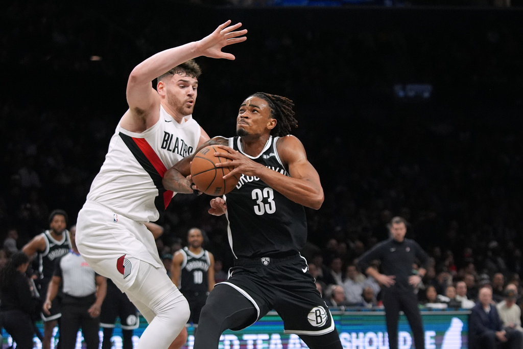 Portland Trail Blazers' Donovan Clingan (23) defends Brooklyn Nets' Nic Claxton (33) during the first half of an NBA basketball game Monday, March 16, 2026, in New York. (AP Photo/Frank Franklin II)