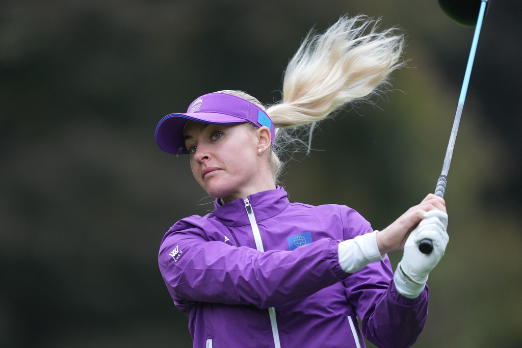 Charley Hull, of World team, tees off on the ninth hole during the semifinal against Australia team for the LPGA International Crown golf tournament at the New Korea Country Club in Goyang, South Korea, Sunday, Oct. 26, 2025. (AP Photo/Lee Jin-man)