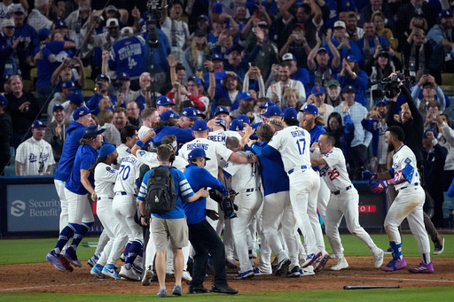 Los Angeles Dodgers players celebrate Freddie Freeman's grand slam home run against the Toronto Blue Jays after Game 3 of baseball's World Series, Monday, Oct. 27, 2025, in Los Angeles. (AP Photo/David J. Phillip) Los Angeles Dodgers players celebrate Freddie Freeman's grand slam home run against the Toronto Blue Jays after Game 3 of baseball's World Series, Monday, Oct. 27, 2025, in Los Angeles. (AP Photo/David J. Phillip)