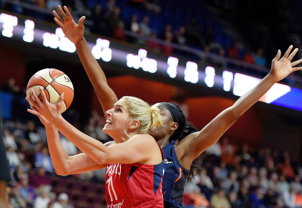 FILE - In this June 13, 2018, file photo, Washington Mystics forward Elena Delle Donne (11) shoots past Connecticut Sun forward Chiney Ogwumike during the first half of a WNBA basketball game in Uncasville, Conn. (Sean D. Elliot/The Day via AP, File)