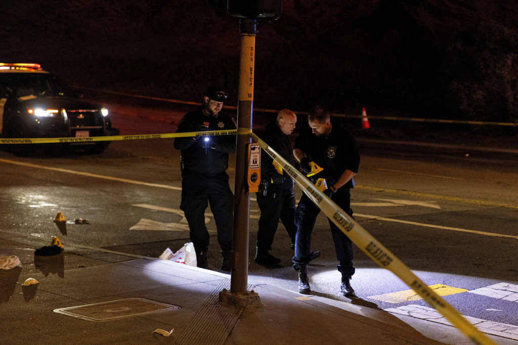 Officers with the San Francisco Police Department investigate the scene of a shooting near Ocean Beach in San Francisco, Saturday, Nov. 8, 2025. (Stephen Lam/San Francisco Chronicle via AP)