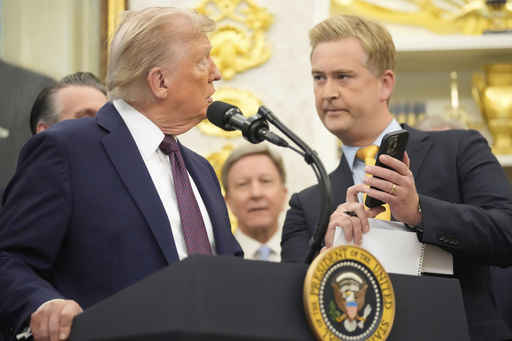 FILE - FOX News reporter Peter Doocy, right, shows President Donald Trump a photo on his phone during an event about the relocation of U.S. Space Command headquarters from Colorado to Alabama in the Oval Office of the White House, Sept. 2, 2025, in Washington. (AP Photo/Mark Schiefelbein, File) FILE - FOX News reporter Peter Doocy, right, shows President Donald Trump a photo on his phone during an event about the relocation of U.S. Space Command headquarters from Colorado to Alabama in the Oval Office of the White House, Sept. 2, 2025, in Washington. (AP Photo/Mark Schiefelbein, File)