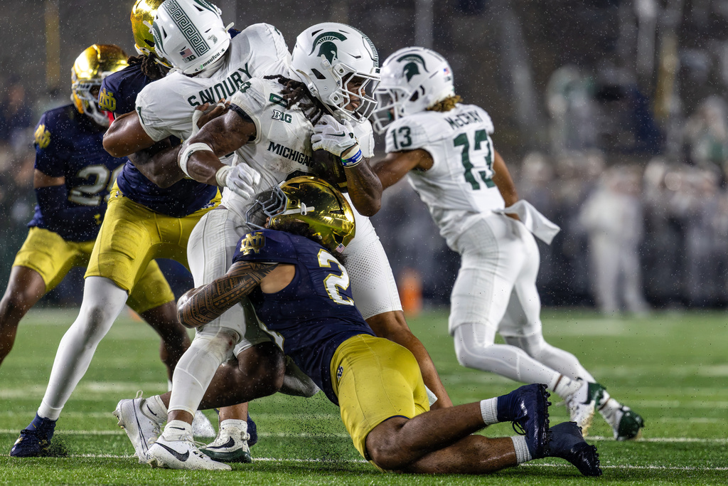 Notre Dame linebacker Kyngstonn Viliamu-Asa (27) tackles Michigan State running back Cam Edwards (0) during the first half of a college football game, Saturday, Sept. 19, 2026, in South Bend, Ind. (AP Photo/Paul Barnick)