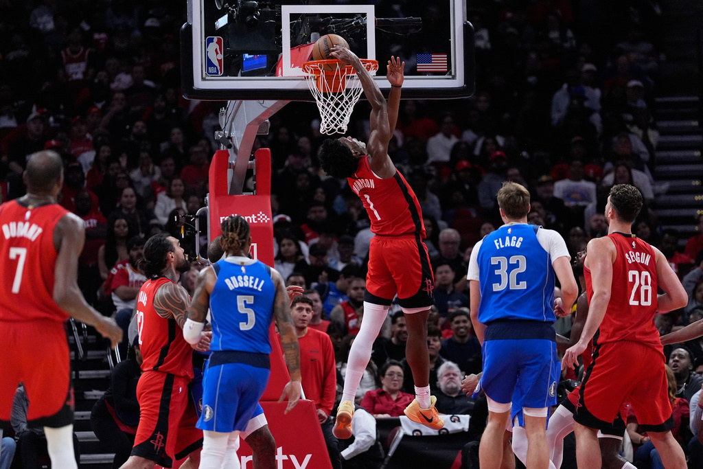 Houston Rockets guard Amen Thompson (1) dunks during the first half of an NBA basketball game against the Dallas Mavericks in Houston, Monday, Nov. 3, 2025. (AP Photo/Ashley Landis)