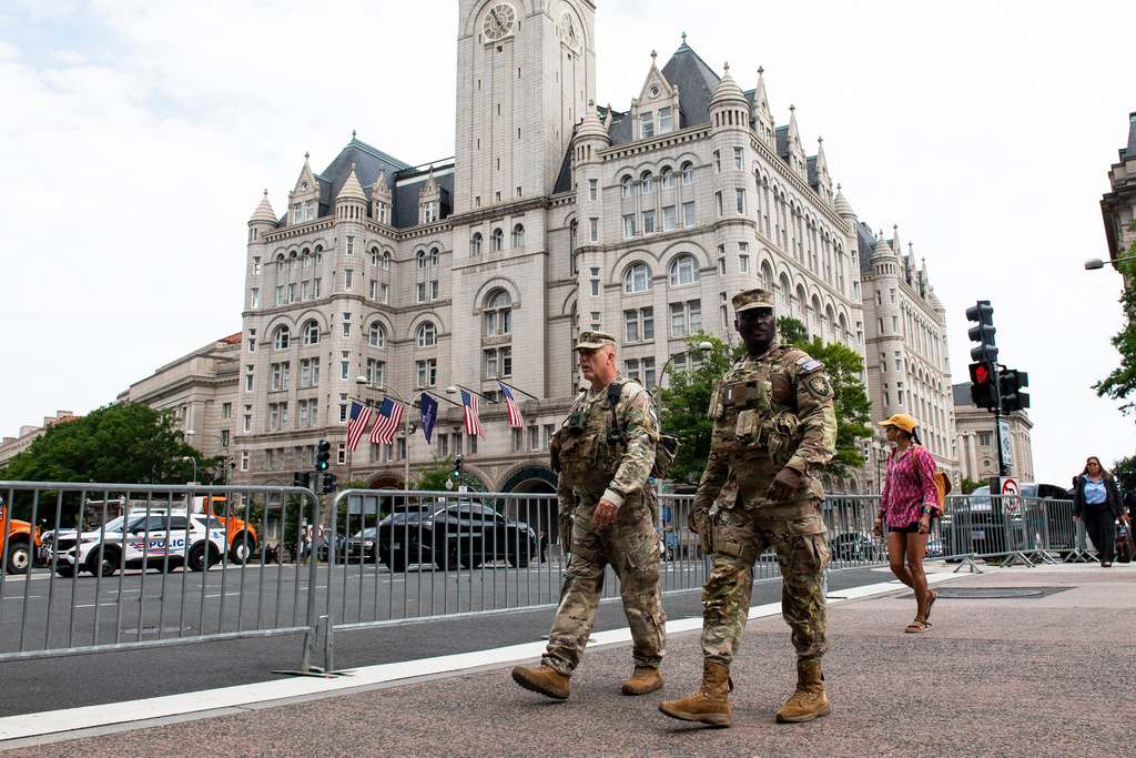 National Guard troops walk across the street from the Waldorf Astoria hotel where President Donald Trump will attend the White House Correspondents' Association Dinner, in Washington, Friday, July 24, 2026. (AP Photo/Cliff Owen)