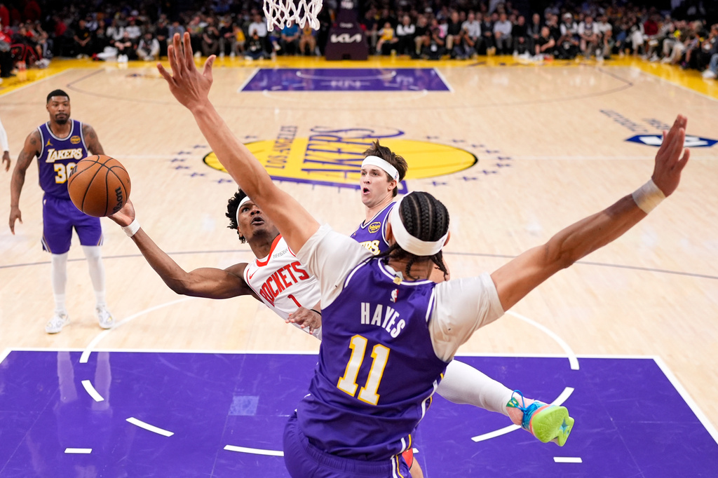 Houston Rockets guard Amen Thompson, left, shoots as Los Angeles Lakers center Jaxson Hayes defends during the first half in Game 5 of a first-round NBA playoffs basketball series Wednesday, April 29, 2026, in Los Angeles. (AP Photo/Mark J. Terrill)