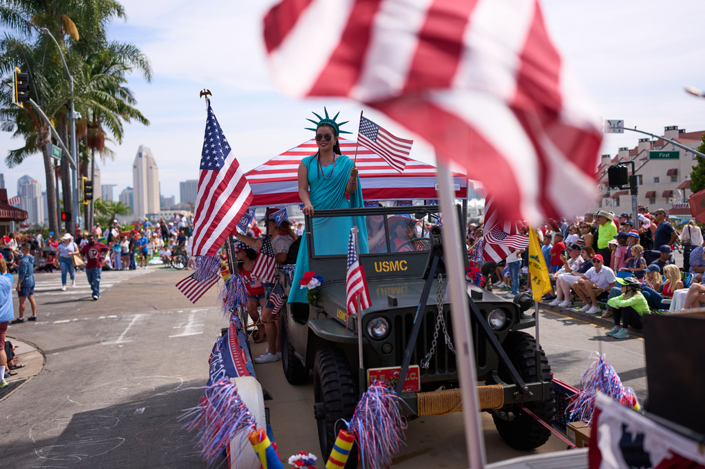 People look on during an Independence Day parade Saturday, July 4, 2026, in Coronado, Calif. (AP Photo/Gregory Bull)