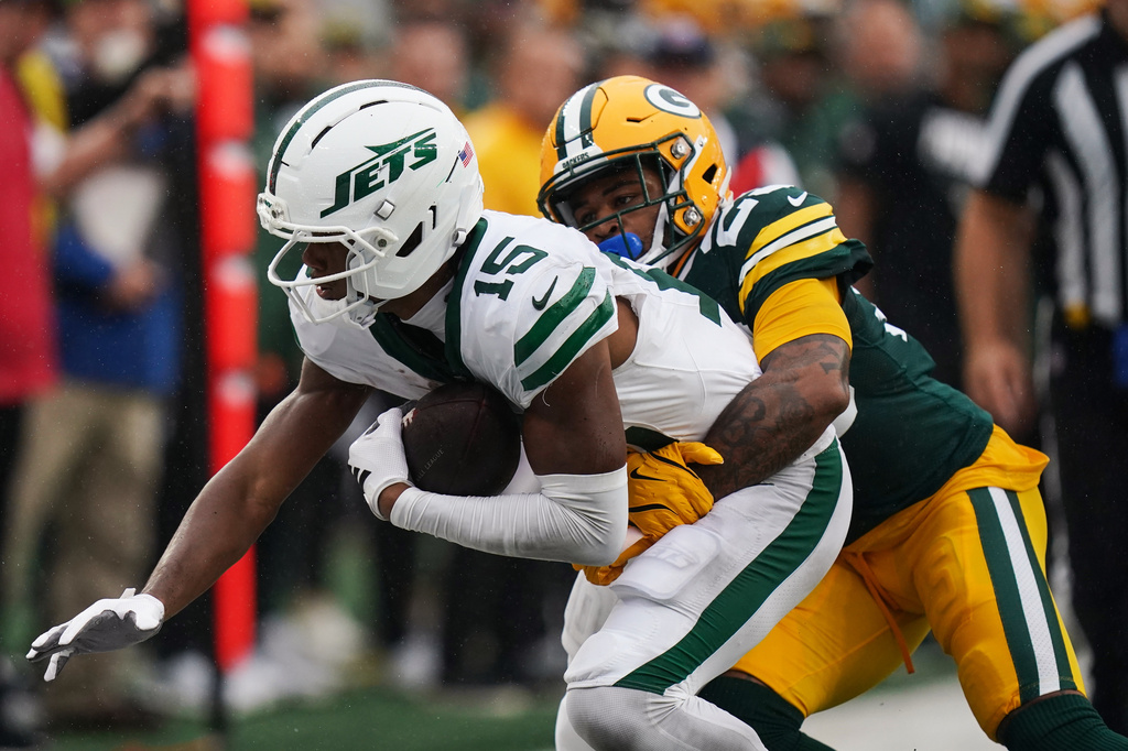 FILE - New York Jets wide receiver Adonai Mitchell (15) gets tackled by Green Bay Packers cornerback Keisean Nixon (25) during an NFL football game in East Rutherford, N.J., Sunday, Sept. 20, 2026. (AP Photo/Vera Nieuwenhuis, File)