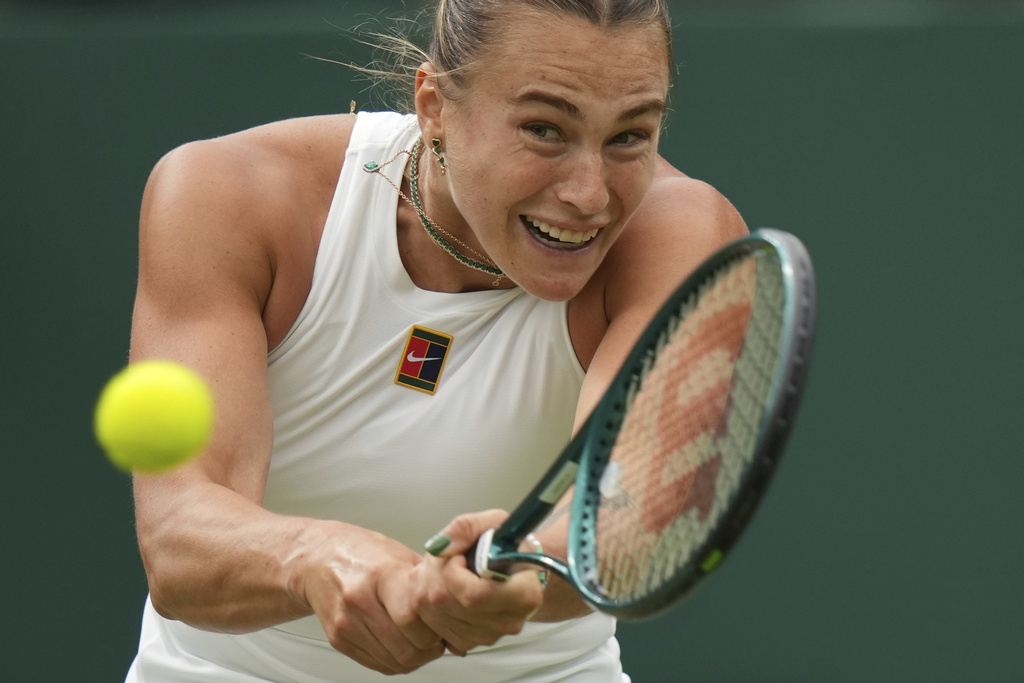 Aryna Sabalenka of Belarus returns to Belgium's Elise Mertens during a fourth round women's singles match at the Wimbledon Tennis Championships in London, Sunday, July 6, 2025. (AP Photo/Alastair Grant)