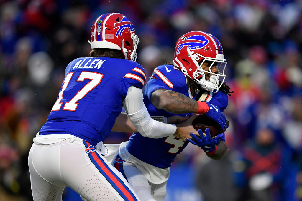 Buffalo Bills quarterback Josh Allen (17) hands off to running back James Cook III (4) in the first half of an NFL football game between the Bills and the New York Jets Sunday, Jan. 4, 2026, in Orchard Park, N.Y. (AP Photo/Adrian Kraus)