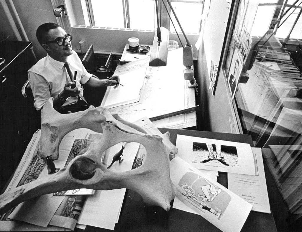 Denver Post cartoonist Pat Oliphant, winner of the 1967 Pulitzer Prize for Editorial Cartooning works in his office in this May, 1967 photograph. (Duane Howell/The Denver Post via AP)