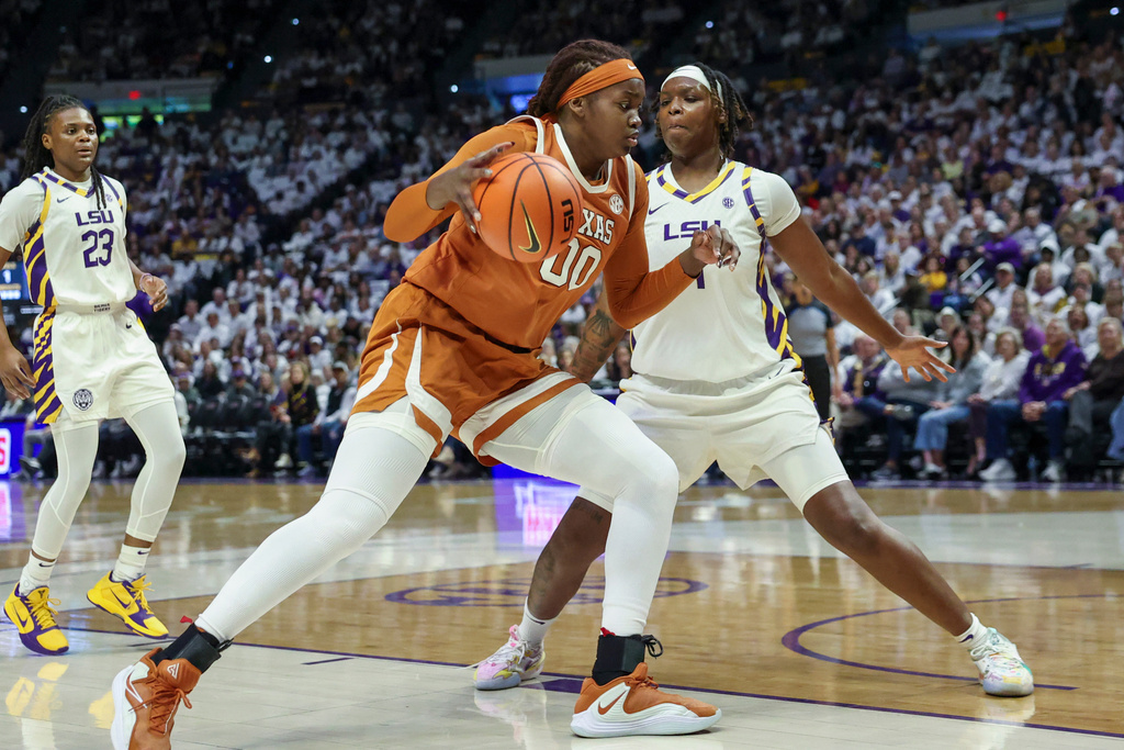 Texas center Kyla Oldacre (00) tries to make a move against LSU forward Amiya Joyner, right, in the first half of an NCAA college basketball game in Baton Rouge, La., Sunday, Jan. 11, 2026. (AP Photo/Peter Forest)