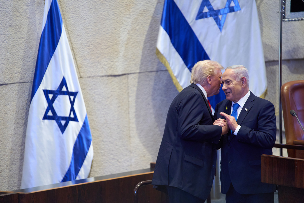 President Donald Trump talks with Israel's Prime Minister Benjamin Netanyahu at the Knesset, Israel's parliament, Monday, Oct. 13, 2025, in Jerusalem. (AP Photo/Evan Vucci, Pool)