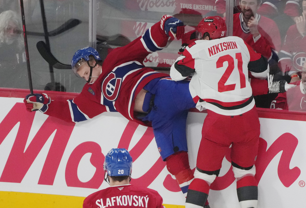 Carolina Hurricanes' Alexander Nikishin (21) checks Montreal Canadiens' Kaiden Guhle during the second period of Game 4 of NHL Eastern Conference final Stanley Cup playoff series game in Montreal on Wednesday, May 27, 2026. (Christinne Muschi/The Canadian Press via AP)