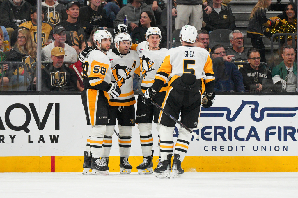 Pittsburgh Penguins right wing Rickard Rakell (67) celebrates his goal against the Vegas Golden Knights with teammates during the second period of an NHL hockey game Thursday, March 12, 2026, in Las Vegas. (AP Photo/Candice Ward)