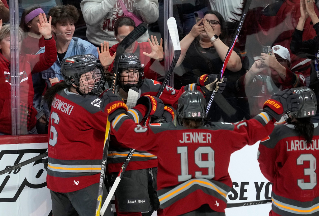Ottawa Charge forward Rebecca Leslie (37) celebrates after her winning goal against the Montreal Victoire with teammates during the third period of Game 3 in the PWHL Walter Cup finals hockey series in Ottawa, Ontario, Monday May 18, 2026. (Adrian Wyld/The Canadian Press via AP)