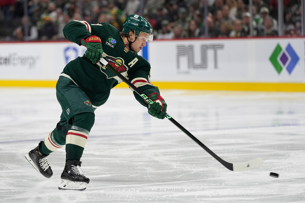 FILE - Minnesota Wild left wing Kirill Kaprizov (97) shoots the puck during the third period of an NHL hockey game against the San Jose Sharks, April 9, 2025, in St. Paul, Minn. (AP Photo/Abbie Parr, file)