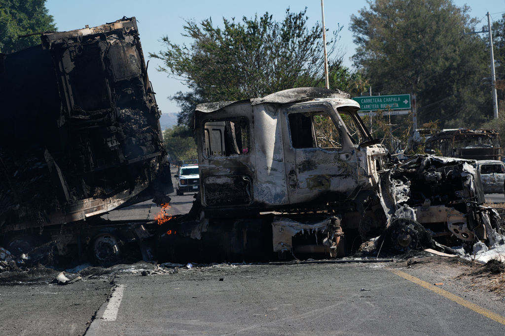 A charred truck blocks a road the day after the Mexican army killed Jalisco New Generation Cartel leader Nemesio Oseguera Cervantes, known as "El Mencho," in Guadalajara, Mexico, Monday, Feb. 23, 2026. (AP Photo/Marco Ugarte)