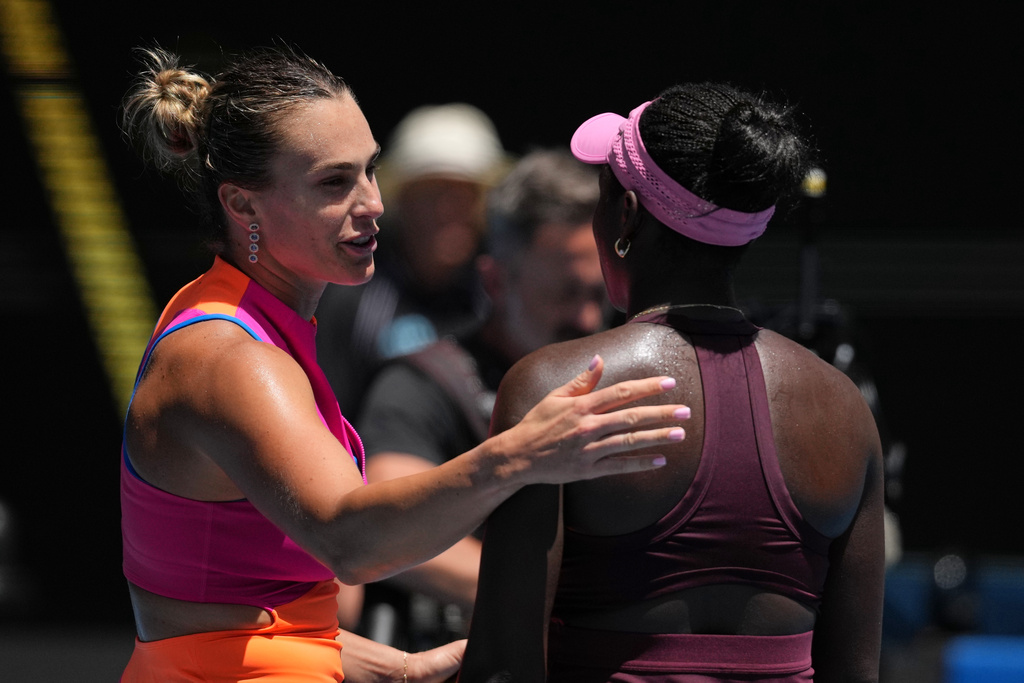 Aryna Sabalenka, left, of Belarus is congratulated by Victoria Mboko, right, of Canada following their fourth round match at the Australian Open tennis championship in Melbourne, Australia, Sunday, Jan. 25, 2026. (AP Photo/Dita Alangkara)