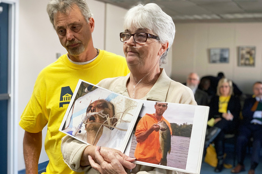 FILE - Sandy Ray holds photos of her son, Steven Davis, during a press conference at the Alabama Statehouse on Dec. 4, 2019, in Montgomery, Ala. (AP Photo/Kim Chandler, File) FILE - Sandy Ray holds photos of her son, Steven Davis, during a press conference at the Alabama Statehouse on Dec. 4, 2019, in Montgomery, Ala. (AP Photo/Kim Chandler, File)