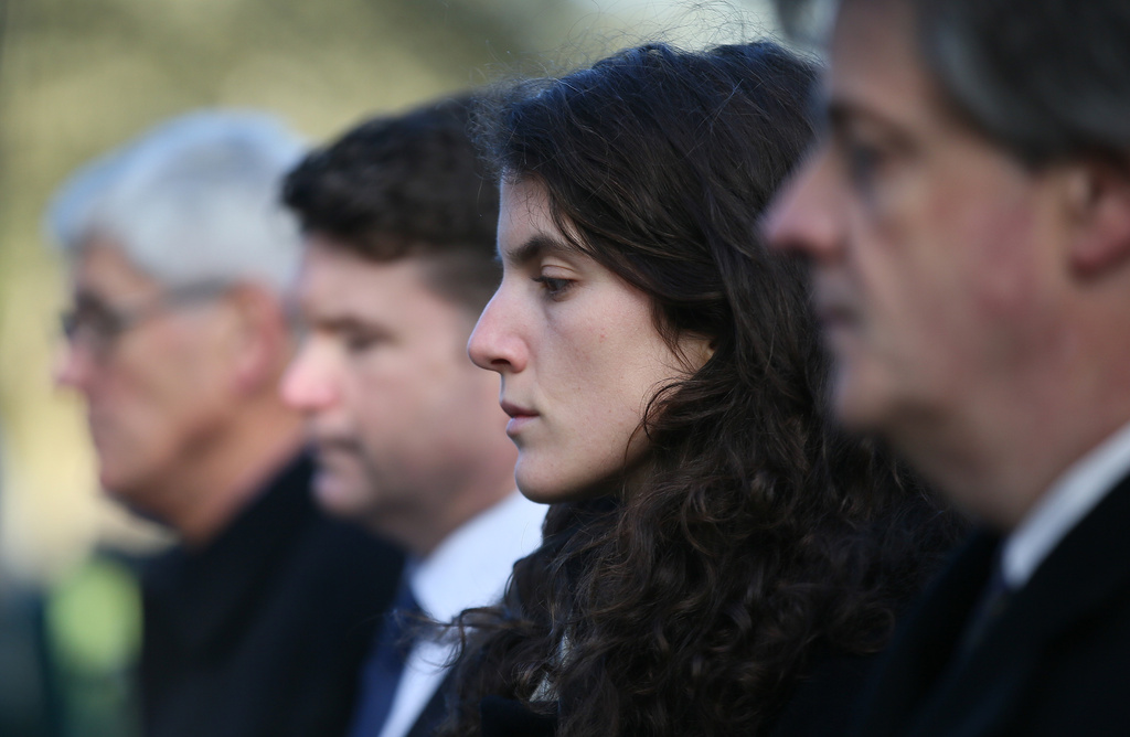 FILE - Tatiana Schlossberg, second right, granddaughter of President J.F. Kennedy pauses for a moment of silence during a short ceremony at the JFK memorial Runnymede, England, Friday, Nov. 22, 2013. (AP Photo/Alastair Grant, File)