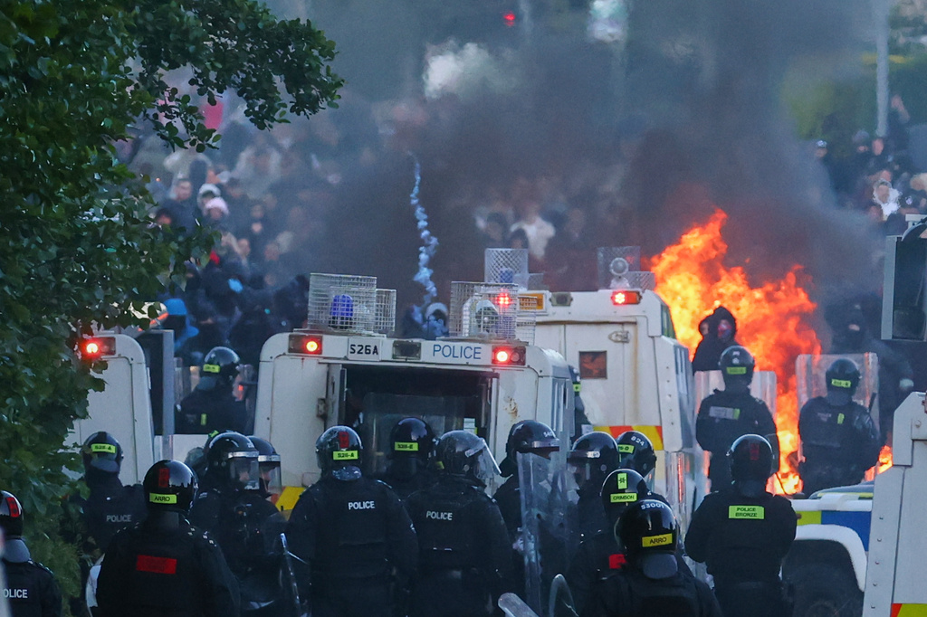 Police attempt to disperse protesters near Newtownabbey, in Belfast, Northern Ireland, Wednesday, June 10, 2026, following a stabbing incident on Monday night. (AP Photo/Peter Morrison)