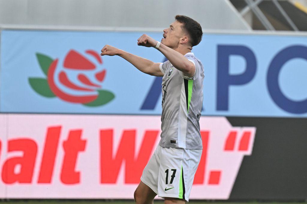 Wolfsburg's Dzenan Pejcinovic celebrates after scoring the opening goal during the soccer relegation match between German second division team SC Paderborn and German first division team VfL Wolfsburg in Paderborn, Germany, Monday, May 25, 2026. (Swen Pfoertner/dpa via AP)