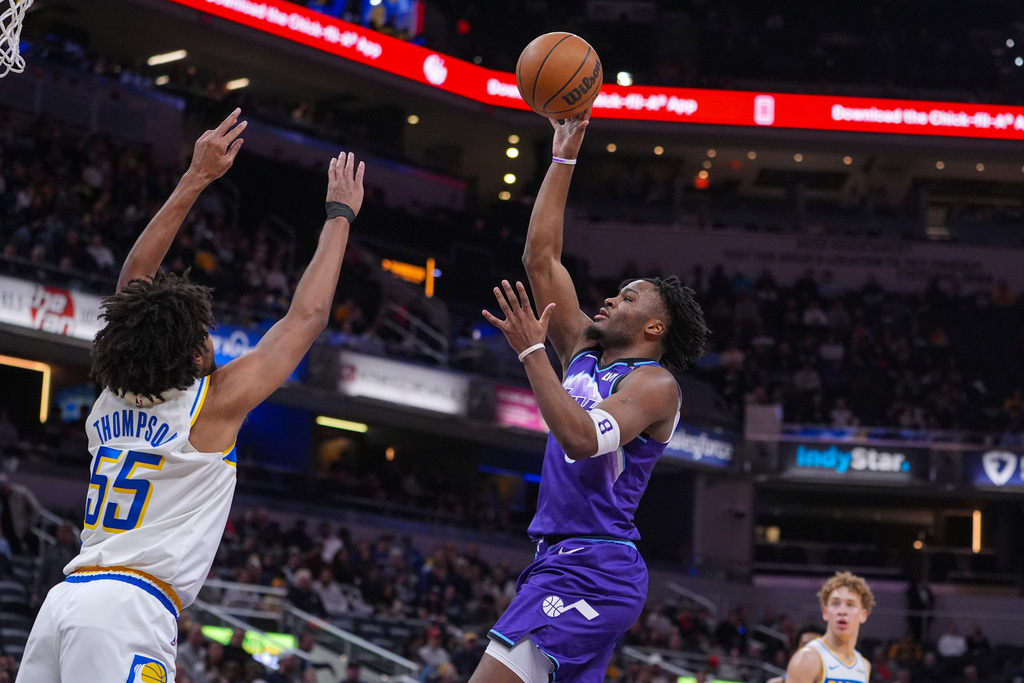 Utah Jazz guard Isaiah Collier (8) shoots over Indiana Pacers guard Ethan Thompson (55) during the second half of an NBA basketball game in Indianapolis, Tuesday, Feb. 3, 2026. (AP Photo/Michael Conroy)