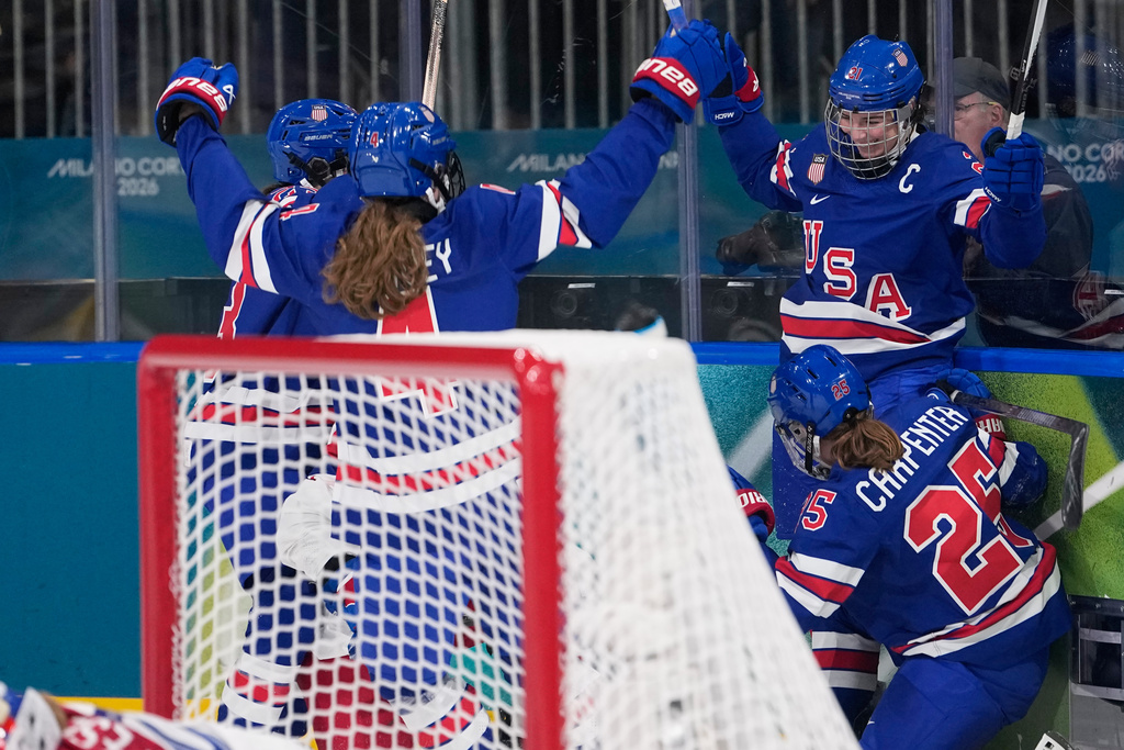 United States' Hilary Knight, right, celebrates with teammates after scoring her sides fourth goal during a preliminary round match of women's ice hockey between United States and Czechia at the 2026 Winter Olympics, in Milan, Italy, Thursday, Feb. 5, 2026. (AP Photo/Petr David Josek)