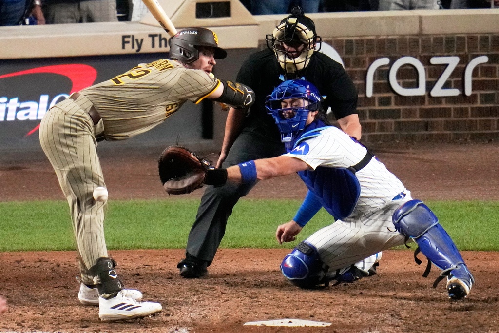 San Diego Padres' Ryan O'Hearn is hit by a pitch during the ninth inning of Game 3 of a National League wild card baseball game against the Chicago Cubs Thursday, Oct. 2, 2025, in Chicago. (AP Photo/Erin Hooley)
