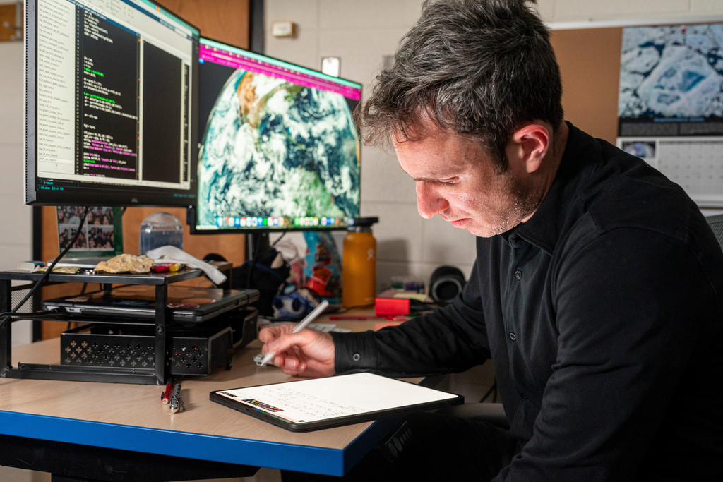 University of Wisconsin-Madison professor Ángel F. Adames Corraliza works on calculations in his office at the Department of Atmospheric and Oceanic Sciences in Madison, Wis., Monday, Oct. 6, 2025. (AP Photo/Andy Manis)