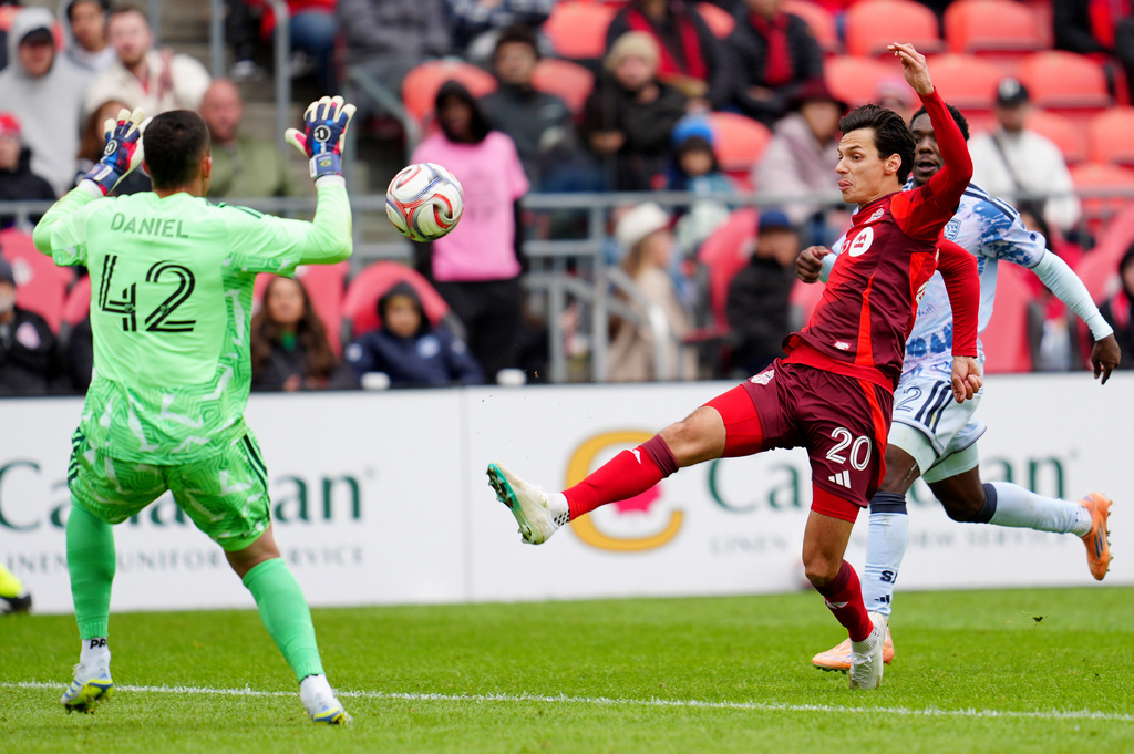 Toronto FC forward Daniel Salloi (20) chips the ball over San Jose Earthquakes goalkeeper Daniel de Sousa Britto (42) during the second half of an MLS soccer game in Toronto, Saturday, May 2, 2026. (Frank Gunn/The Canadian Press via AP)