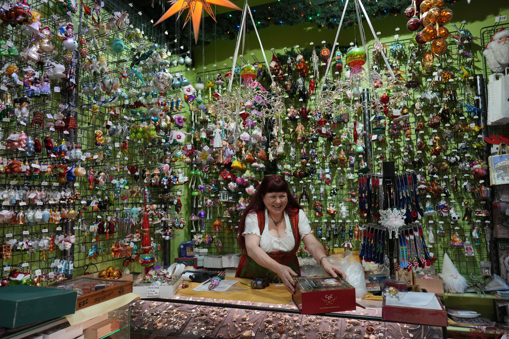 Owner of the Christel Dauwe Collection ornaments shop, Christel Dauwe, wraps boxes of holiday ornaments at her shop in Antwerp, Belgium, Monday, Dec. 8, 2025. (AP Photo/Virginia Mayo)