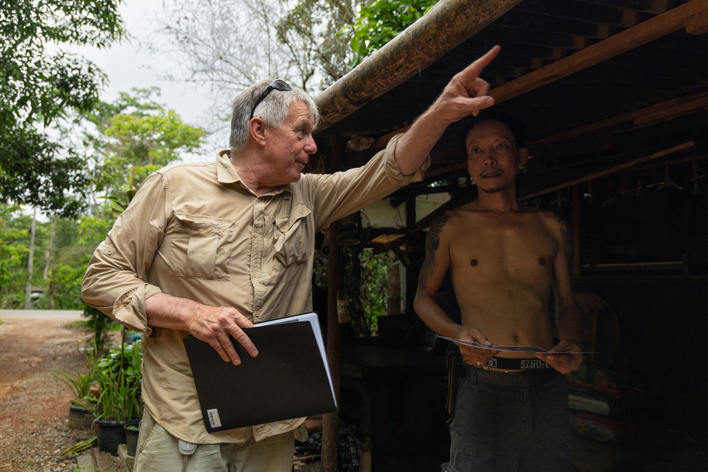 Martyn Fryer, an independent researcher, asks a local landowner for permission to survey a part of the infamous World War II "Death Railway," in Sangkhlaburi, Thailand on Friday, May 29, 2026. (AP Photo/Anton L. Delgado)