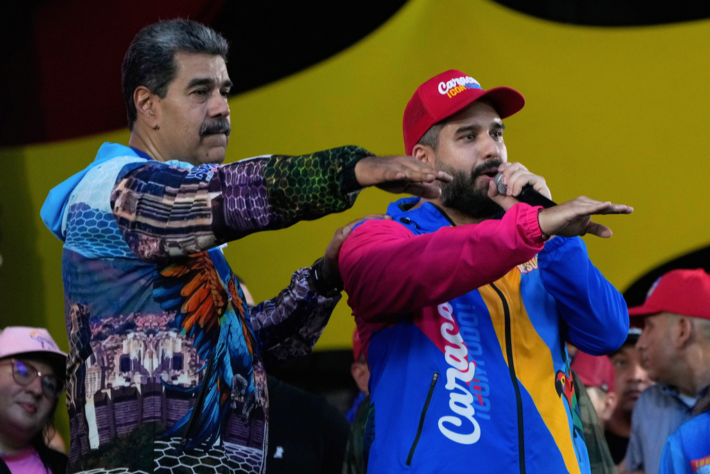 FILE - Venezuelan President Nicolas Maduro, left, and his son Nicolas Maduro Guerra who is running to represent Caracas as a lawmaker for the National Assembly attend a closing campaign rally for the regional election on May 25, in Caracas, Venezuela, May 22, 2025. (AP Photo/Ariana Cubillos, File)