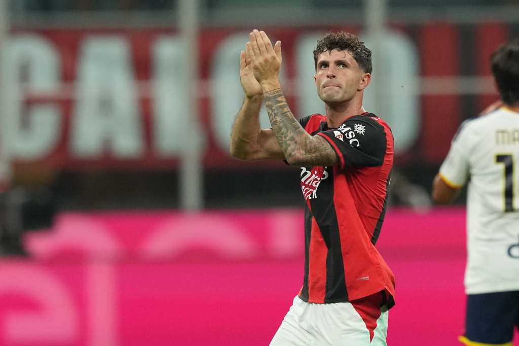 AC Milan's Christian Pulisic greets supporters as he is substituted during the Serie A soccer match between AC Milan and Lecce, in Milan, Italy, Sunday, Sept. 20, 2026. (AP Photo/Antonio Calanni)