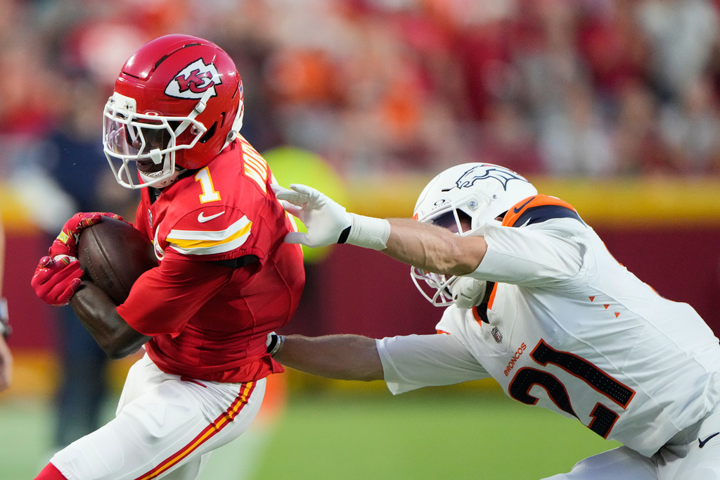 Kansas City Chiefs wide receiver Xavier Worthy (1) is pushed out of bounds by Denver Broncos cornerback Riley Moss (21) during the first half of an NFL football game Monday, Sept. 14, 2026, in Kansas City, Mo. (AP Photo/Charlie Riedel)