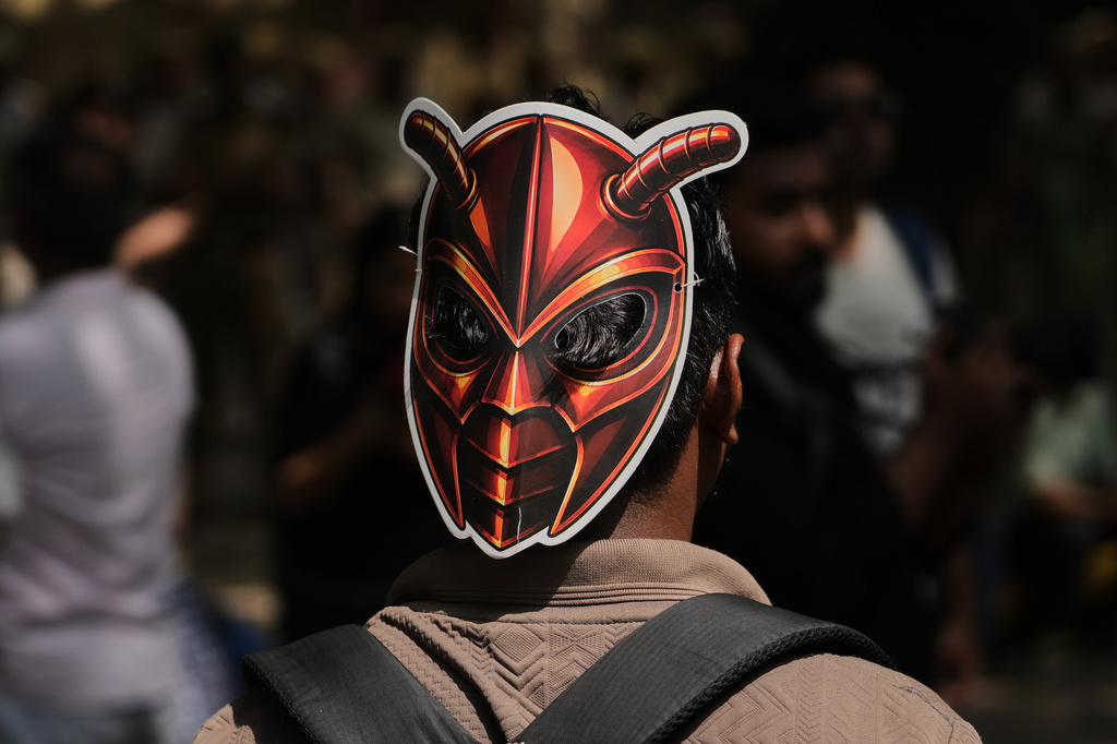 A participant wears a cockroach mask as supporters of the Cockroach Janta Party gather for a protest demonstration in New Delhi, India, Saturday, June 6, 2026. (AP Photo/Manish Swarup)