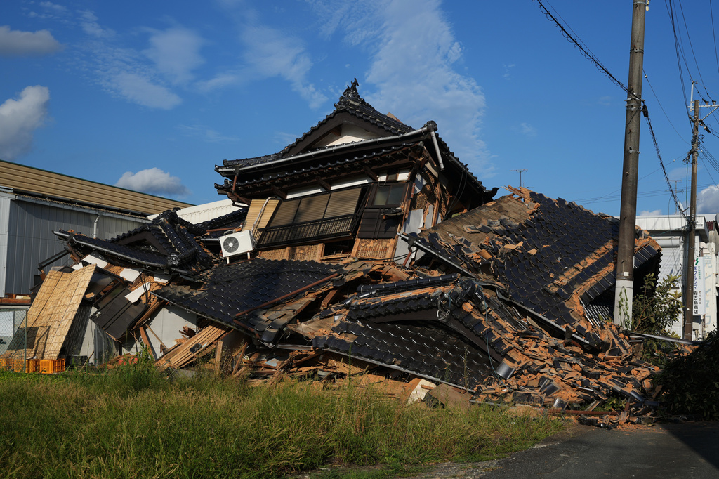 A collapsed building is seen in Yatsushiro, southwestern Japan, Wednesday, July 29, 2026, the day after an earthquake hit the area. (AP Photo/Hiro Komae)