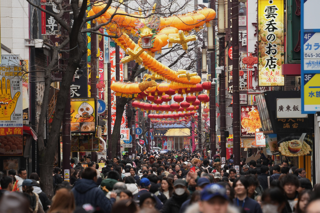 Visitors stroll a street decorated with a big dragon shaped lantern for their Chinese Lunar New Year celebrations, marking the Year of the Horse on the Chinese zodiac, Tuesday, Feb. 17, 2026, at China Town in Yokohama near Tokyo. (AP Photo/Eugene Hoshiko)