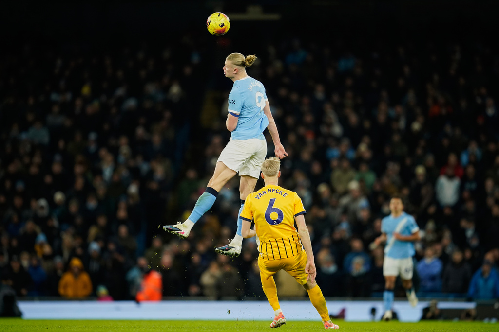 Manchester City's Erling Haaland, top, heads the ball past Brighton's Jan Paul van Hecke during the English Premier League soccer match between Manchester City and Brighton and Hove Albion in Manchester, England, Wednesday, Jan. 7, 2026. (AP Photo/Dave Thompson)