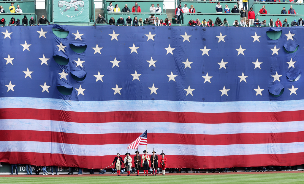 A giant national flag covered the Green Monster left field wall at Fenway Park before the annual Patriot's Day baseball game of the Boston Red Sox and the Detroit Tigers, Monday, April 20, 2026 in Boston. (AP Photo/Jim Davis)