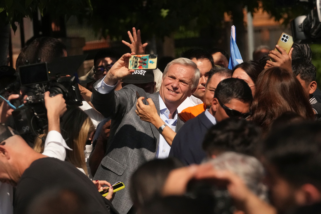 Presidential candidate Jose Antonio Kast of the Republican Party takes a selfie after voting, outside a polling station during general elections in Santiago, Chile, Sunday, Nov. 16, 2025. (AP Photo/Esteban Felix)