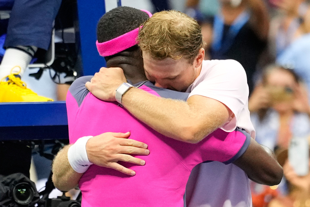 Frances Tiafoe, left, of the United States, and Alex Michelsen, of the United States, embrace after Tiafoe won their match in the quarterfinal round of the U.S. Open tennis championships, Tuesday, Sept. 8, 2026, in New York. (AP Photo/Yuki Iwamura) CORRECTION: Corrects Tiafoe to left, not right.